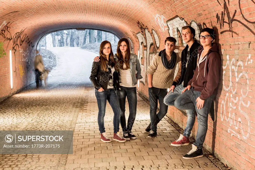 Five teenagers standing in underpass