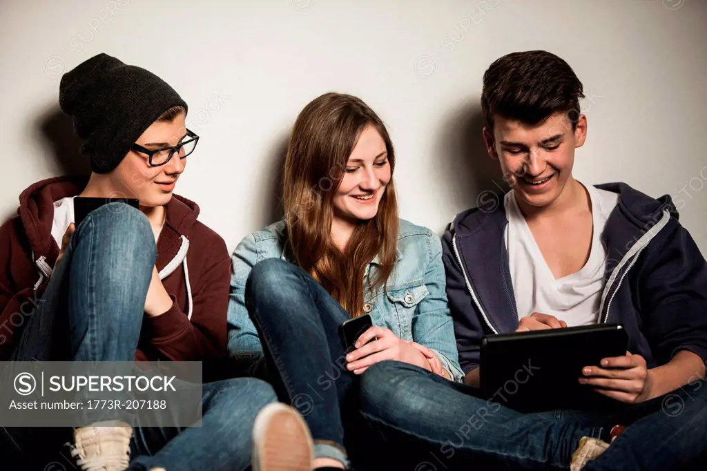 Teenagers using digital tablet