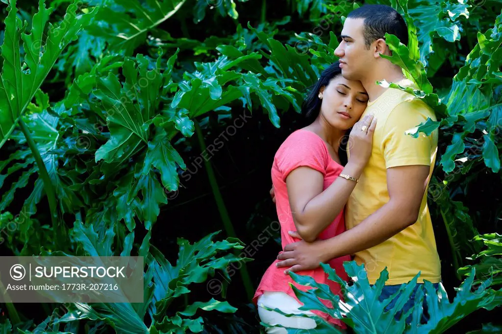 Young couple hugging in plants