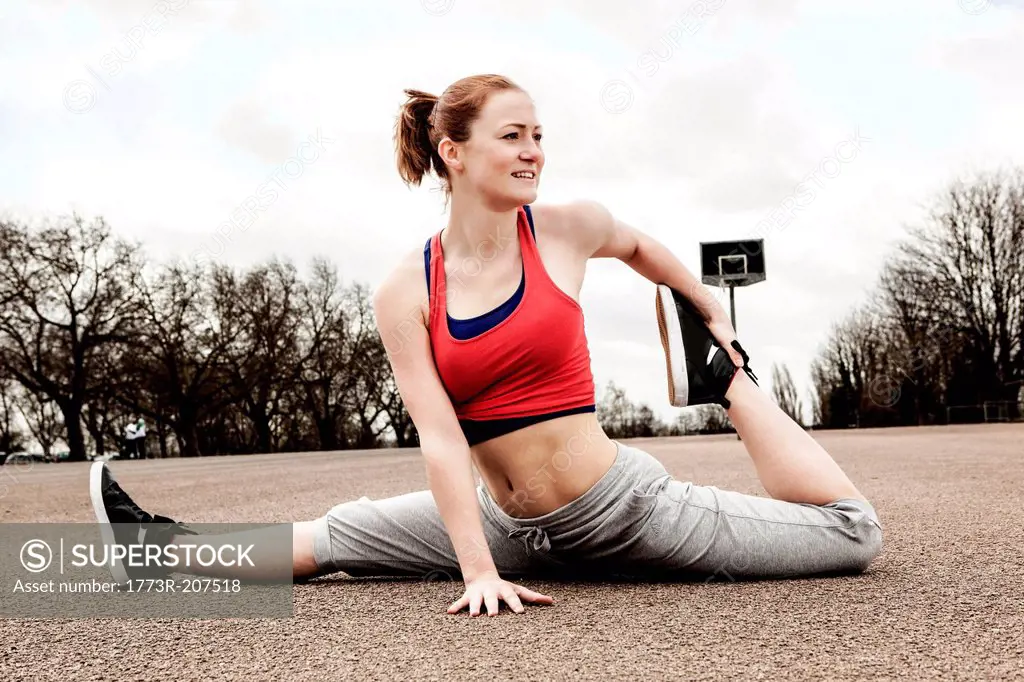 Woman doing splits with left leg bent backwards