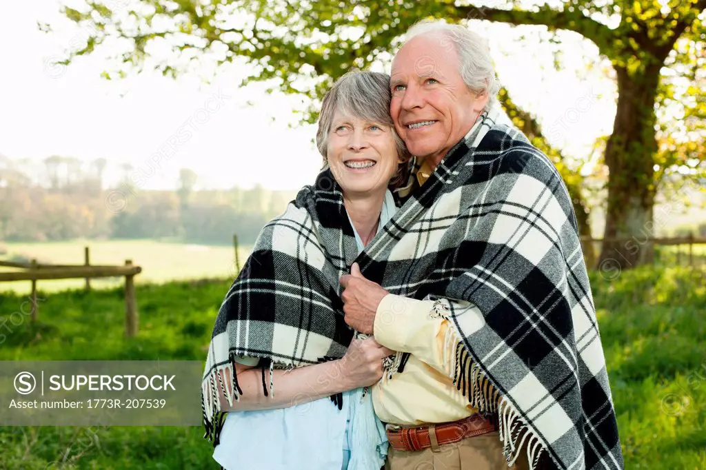 Senior couple wrapped in shawl together