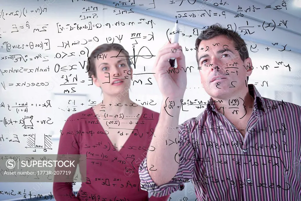 Mathematicians writing complex scientific equations on screen