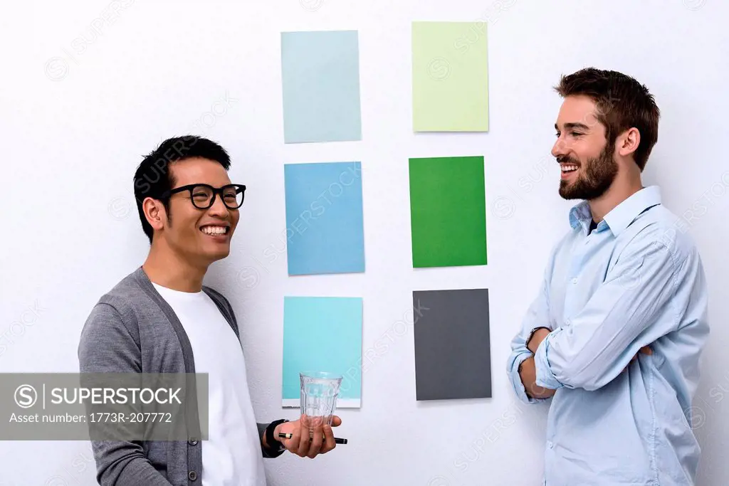 Male designers standing in front of color swatch