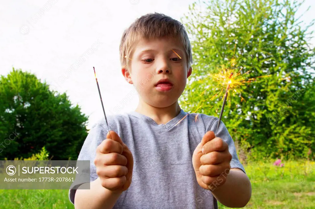 Portrait of boy holding sparklers