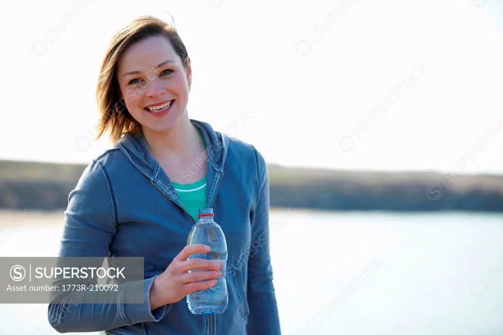 Portrait of young woman at coast taking exercise break