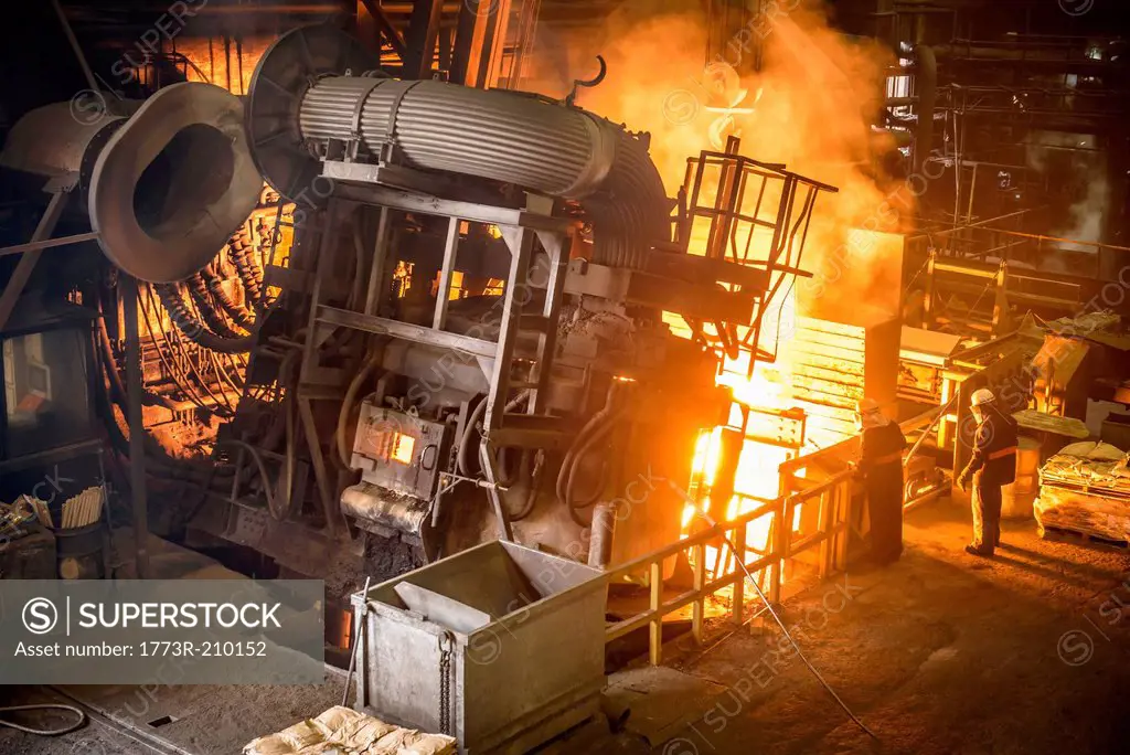 Workers and machinery in steel foundry