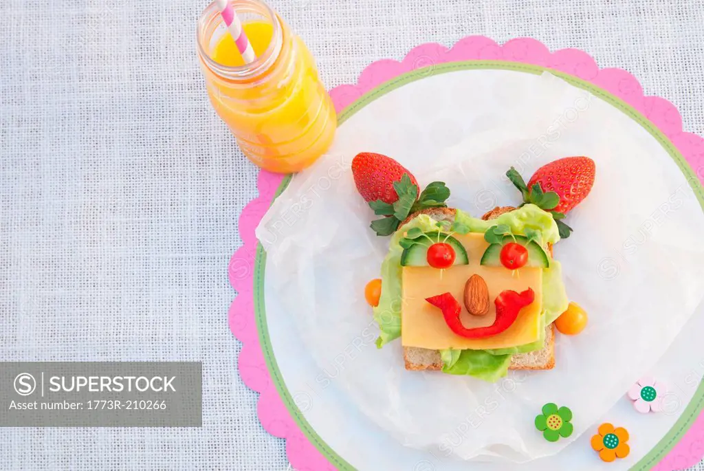 Face made from fresh food on slice of bread