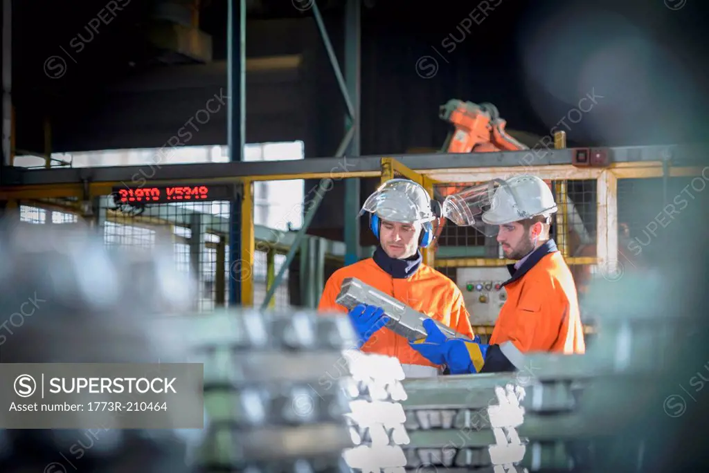 Warehouse workers checking aluminum ingots