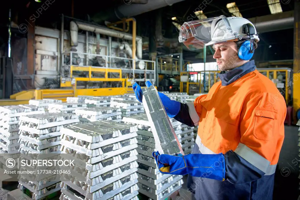 Warehouse worker checking aluminum ingot
