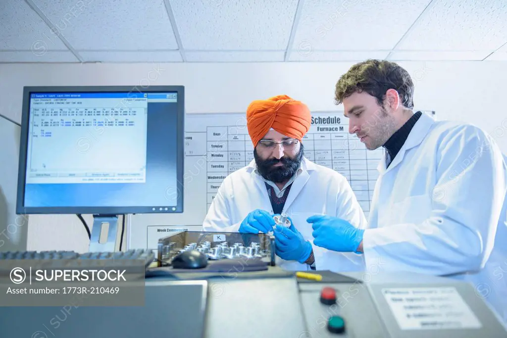 Scientists checking quality of aluminum sample