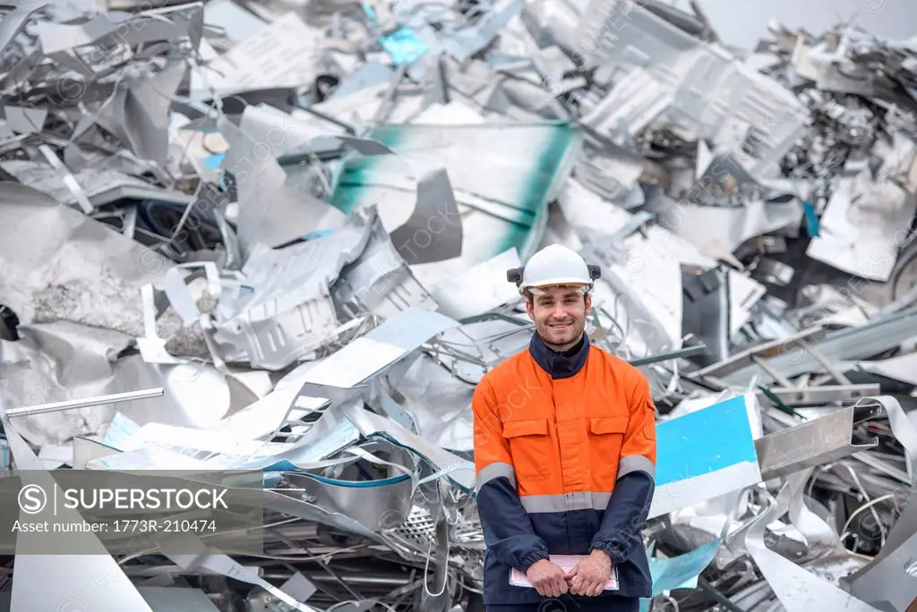 Portrait of worker in front of scrap aluminum
