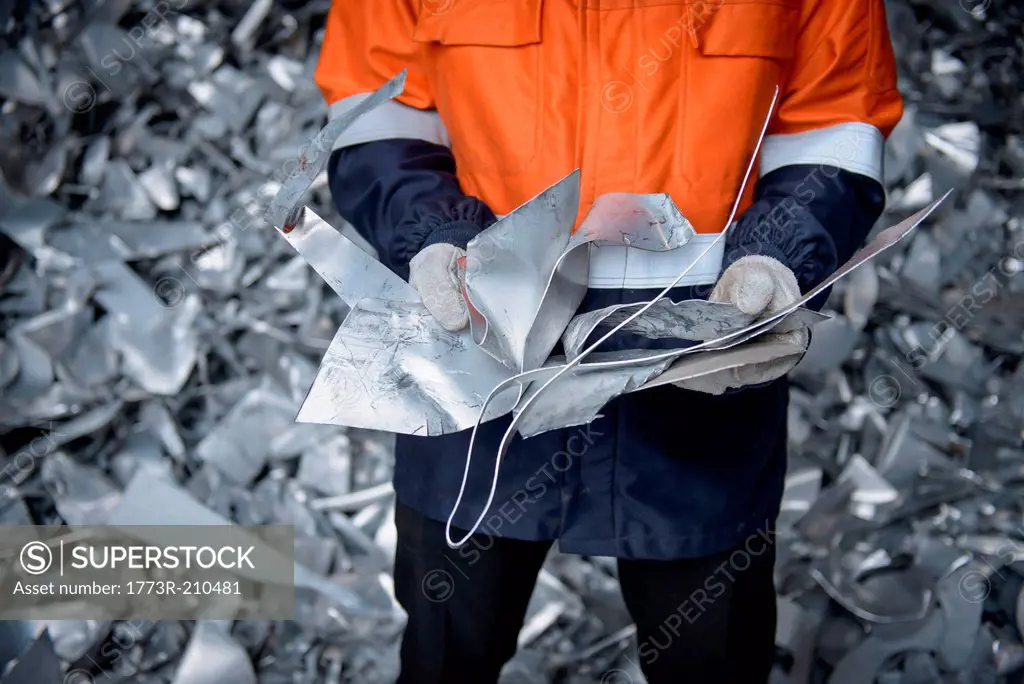 Close up of worker holding scrap aluminum