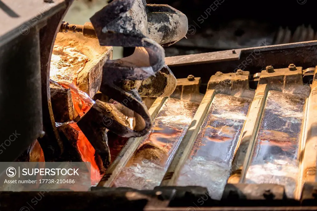 Close up of newly poured metal ingots at aluminum recycling plant