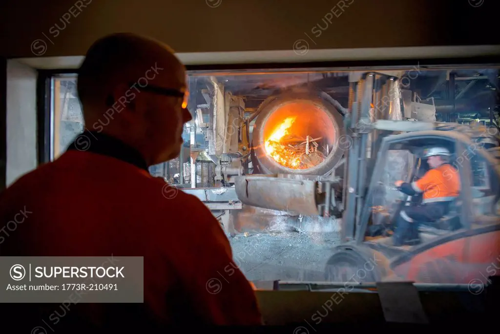 Controller watching furnace at aluminum recycling plant