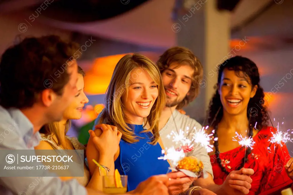 Group of friends enjoying cocktails in bar