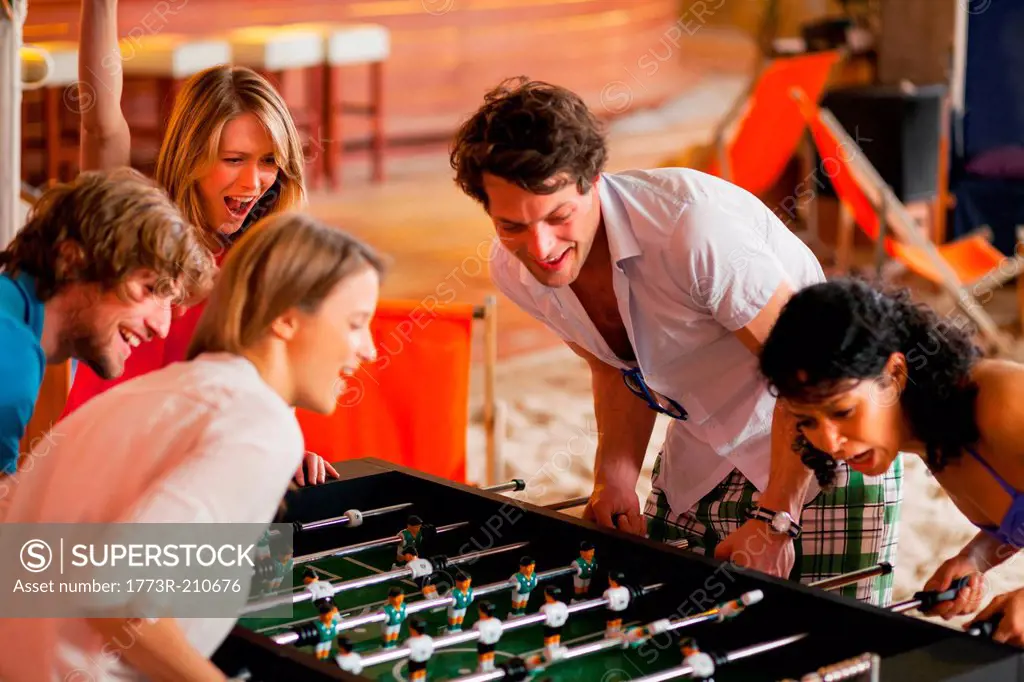 Friends having fun playing table football