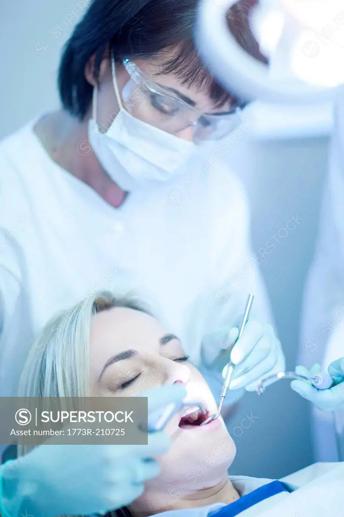 Female dentist examining patients teeth