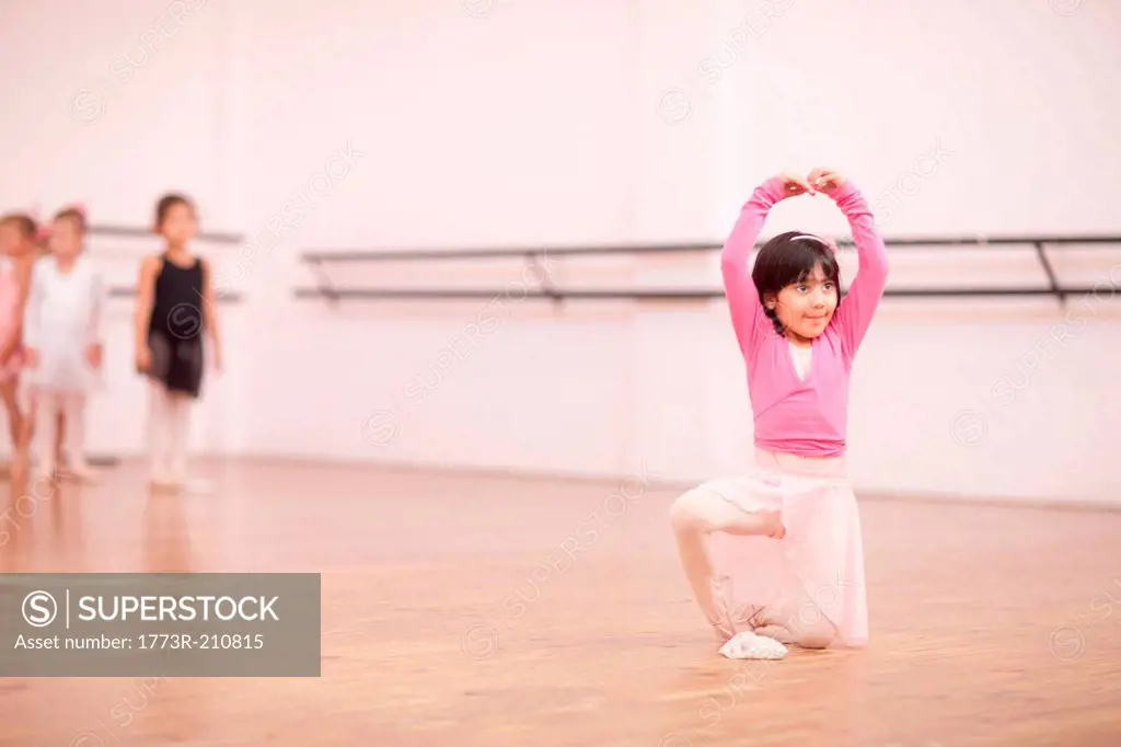 Young ballerina posing in studio