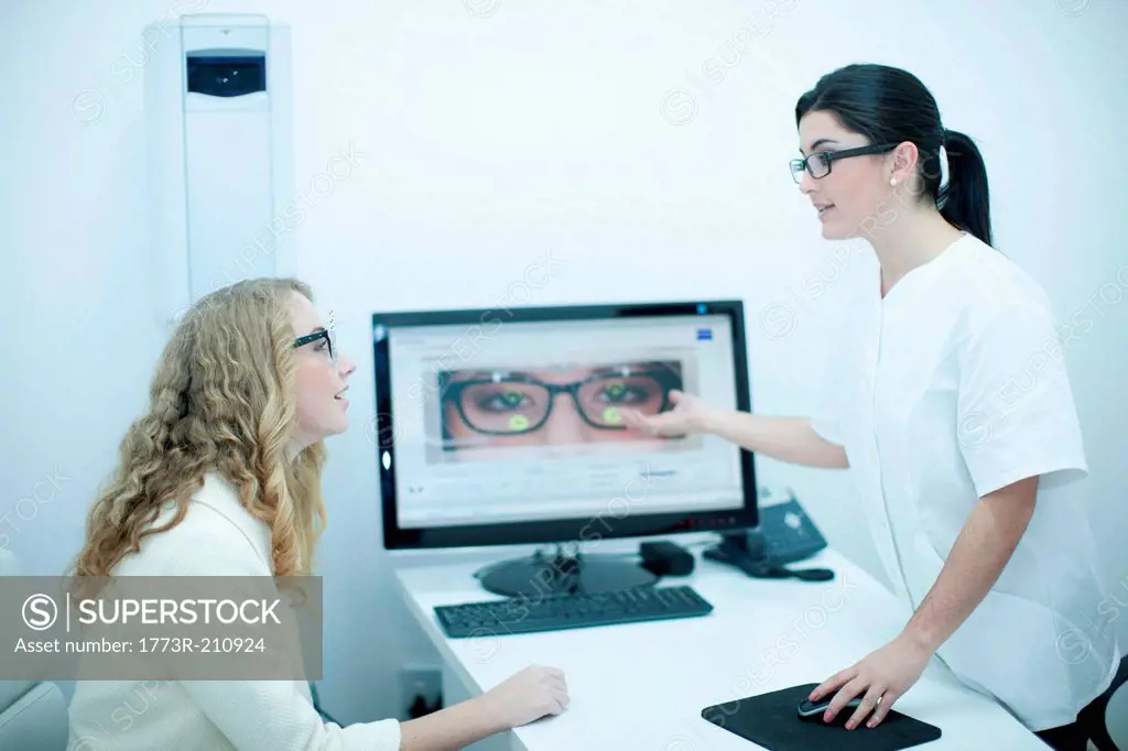Optician guiding patient on choice of eyeglasses