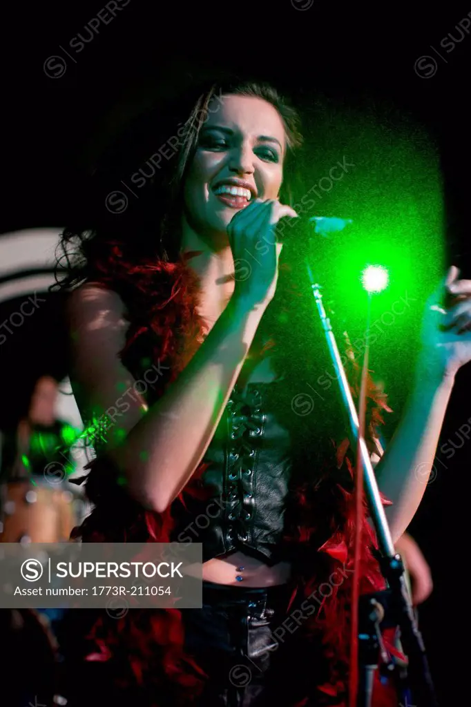 Young female singing on stage in nightclub