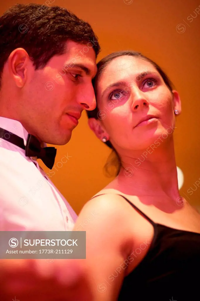 Mid adult woman and young man posing in dance class, close up