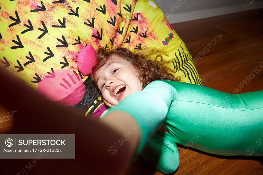 Child on bean bag on floor