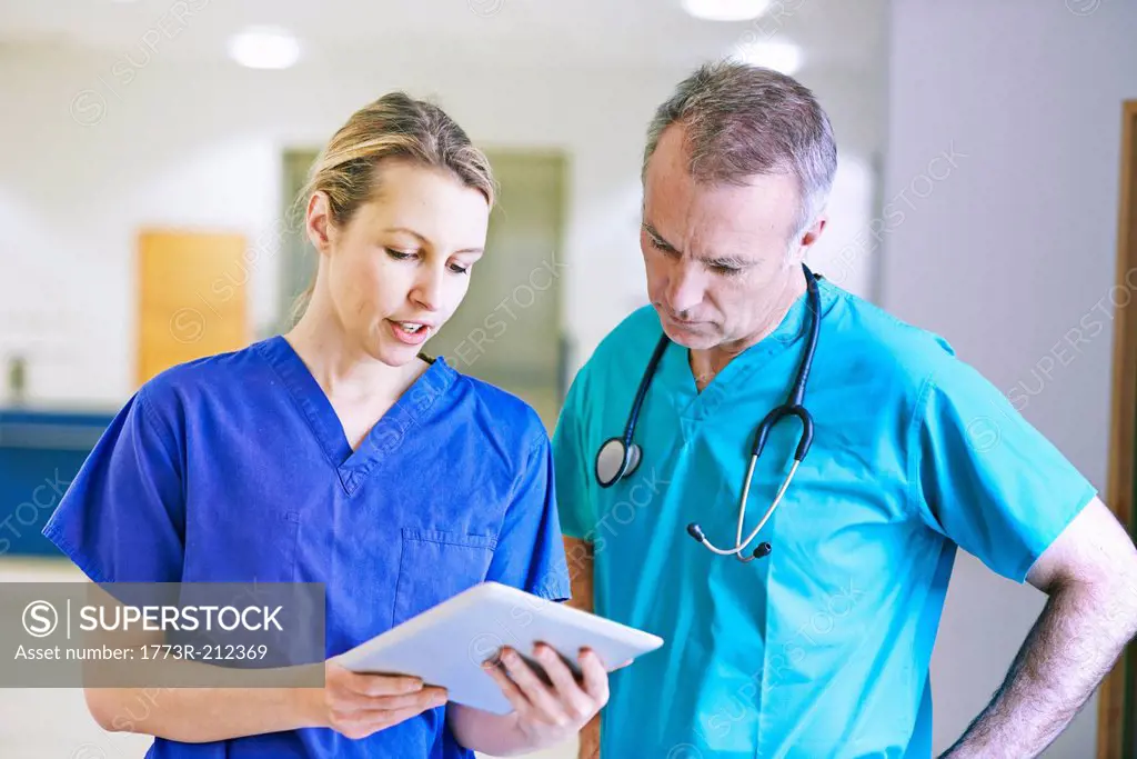 Doctor and surgeon looking at medical records