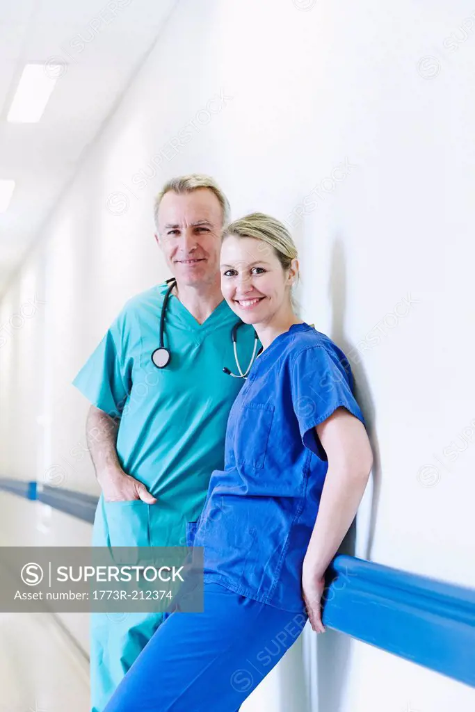 Surgeon and doctor standing in corridor