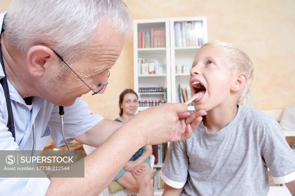 Doctor looking in boy's mouth
