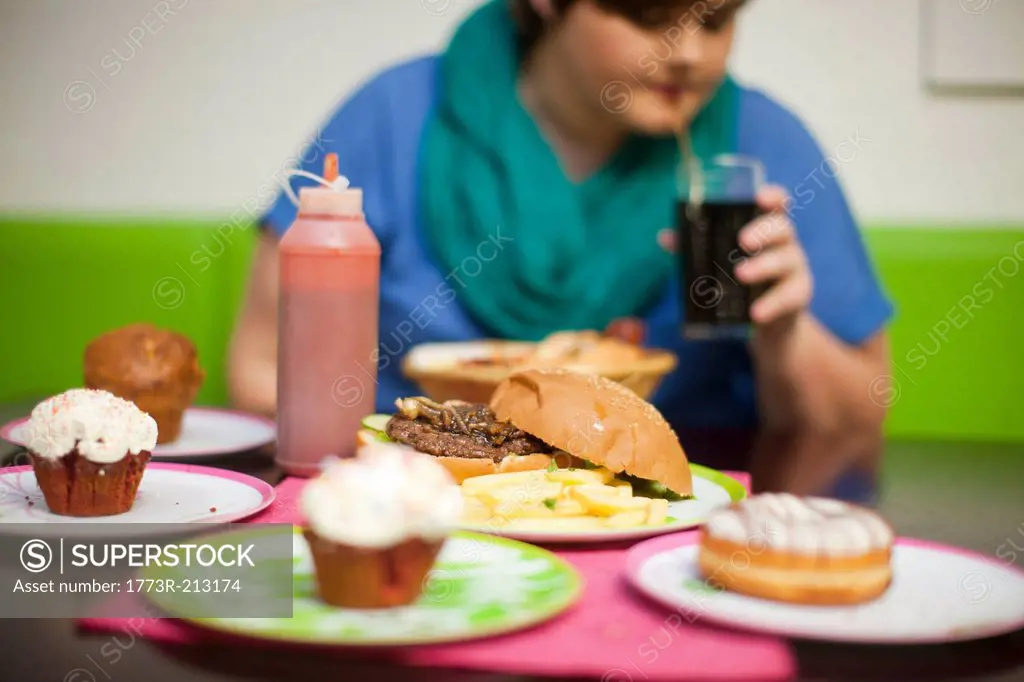 Young woman in cafe with table of food