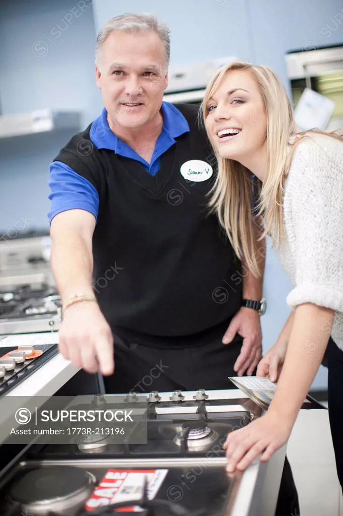 Young woman and salesman in showroom