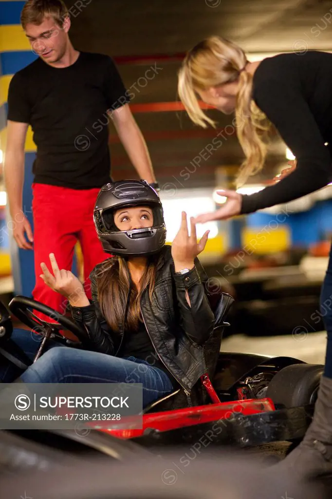 Teenage girl sitting in go cart after accident