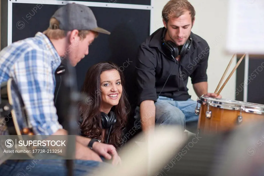 Young musicians taking a break in recording studio