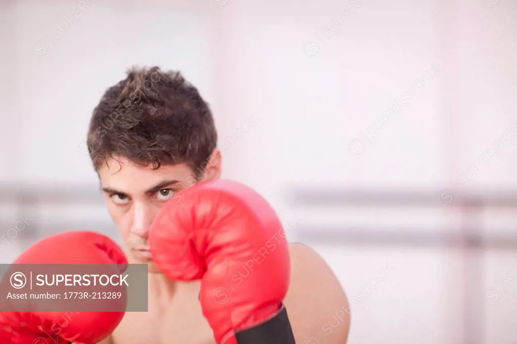Portrait of young man in boxing gloves