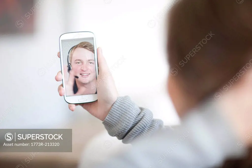 Young woman making video call on cellphone