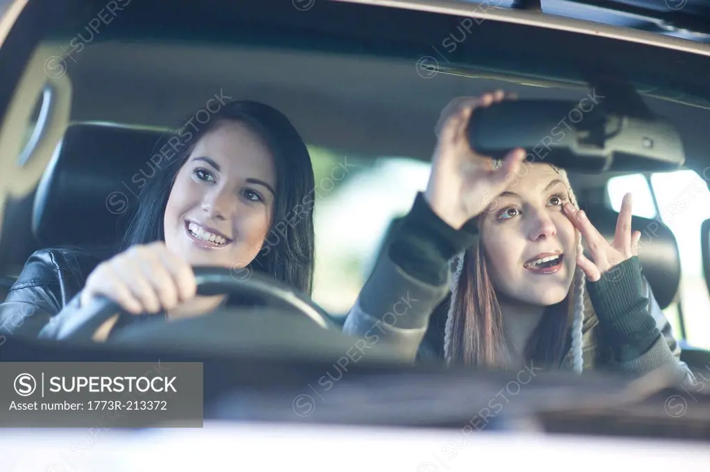 Two young female friends in car