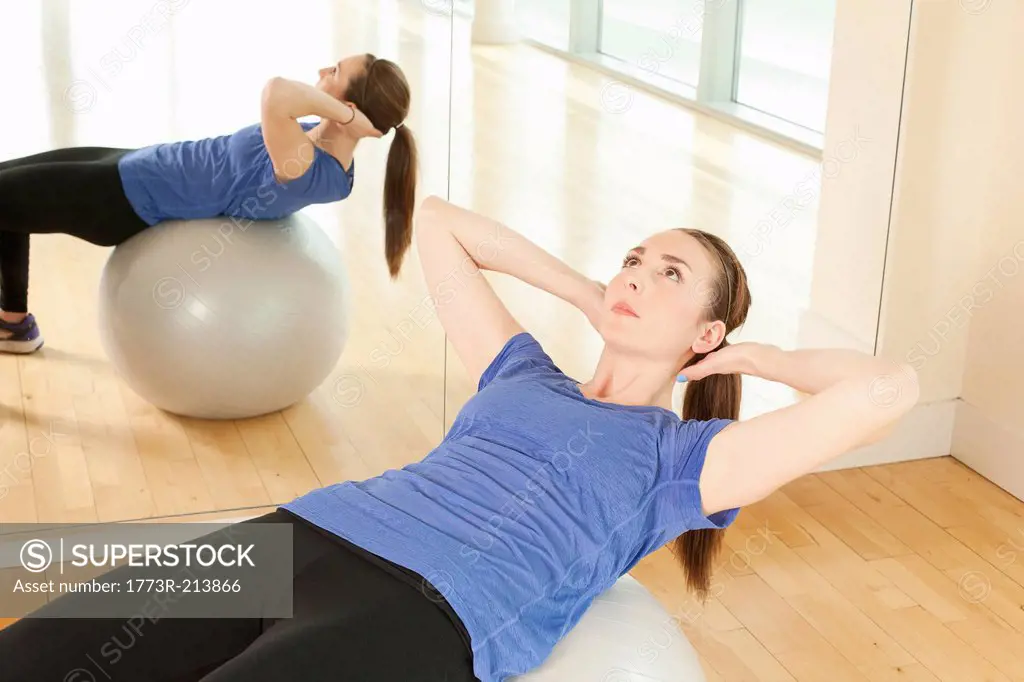 Woman on exercise ball in gymnasium