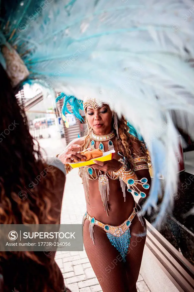 Samba dancers having hot dogs, Rio De Janeiro, Brazil