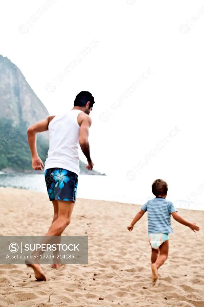 Father and son playing on beach