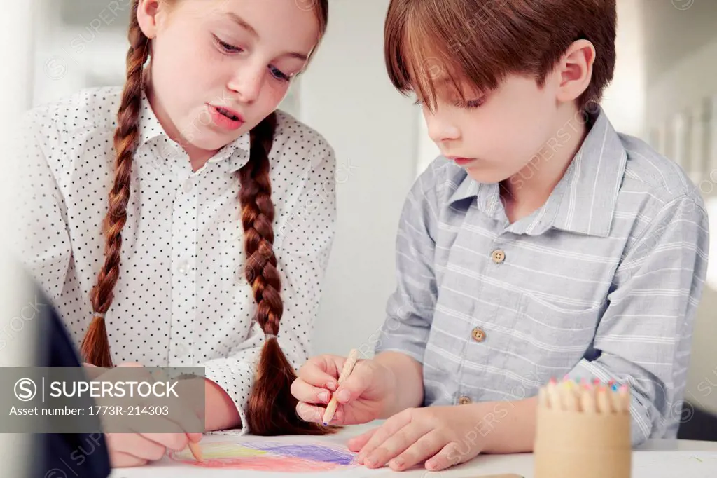 Girl and boy drawing together