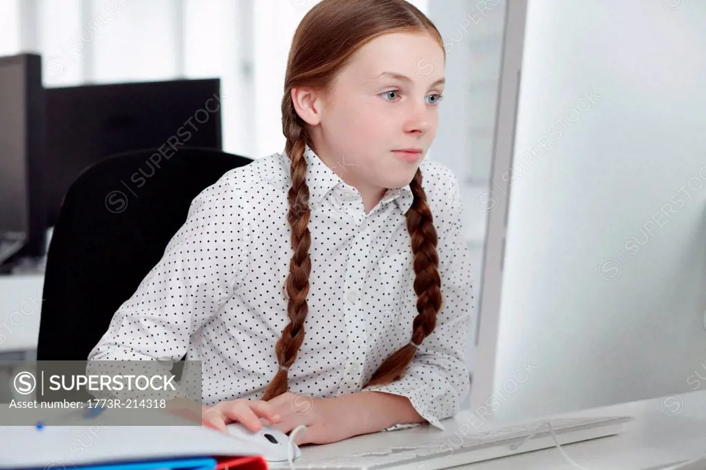 Girl using computer in office