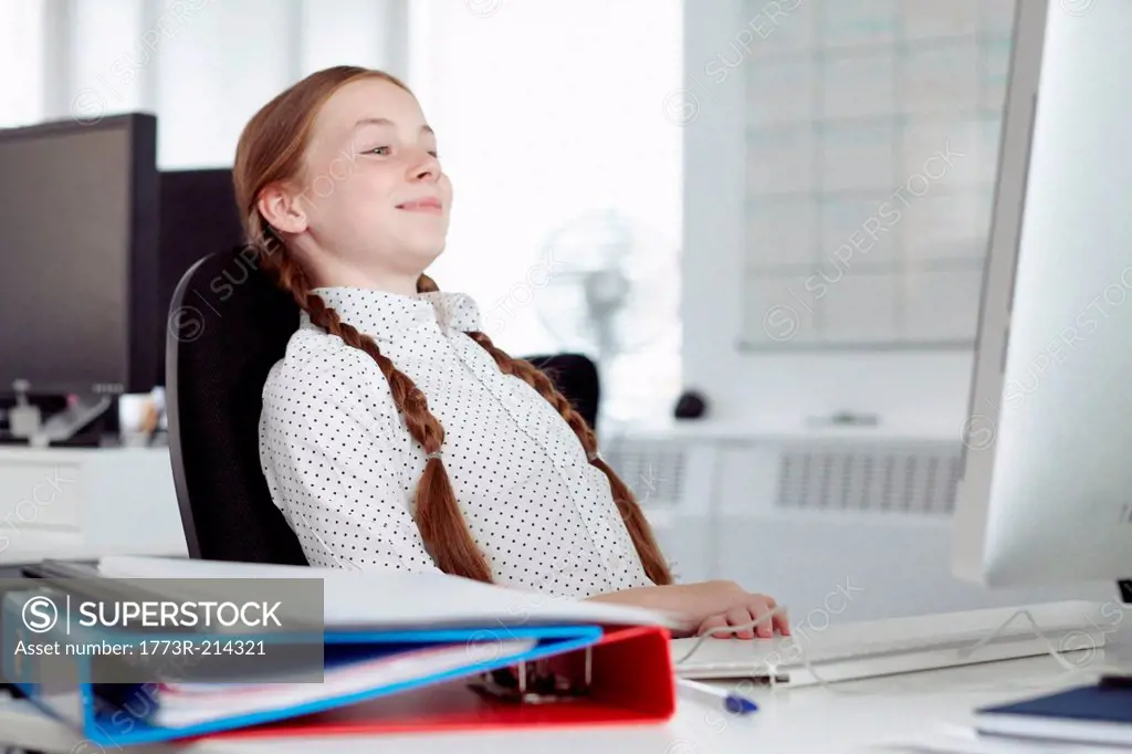 Girl leaning back in office chair