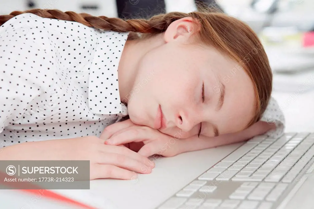 Girl asleep on computer keyboard