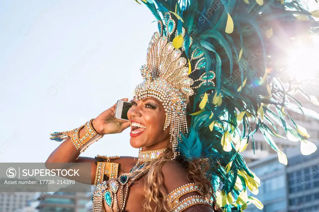 Samba dancer using cellphone, Ipanema Beach, Rio De Janeiro, Brazil