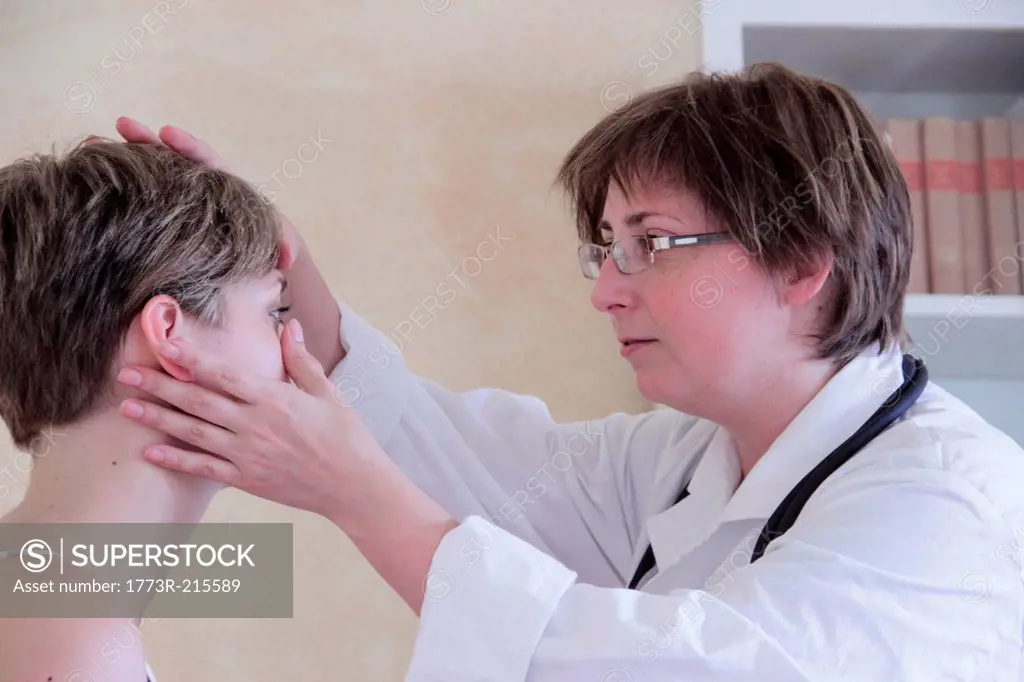Doctor examining woman's face