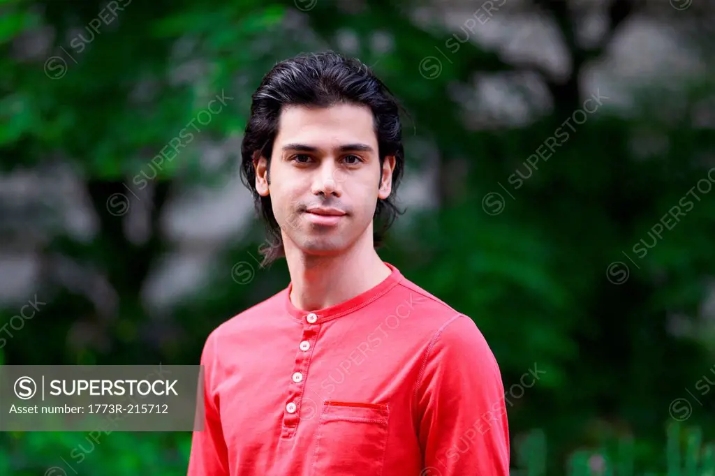 Portrait of young man wearing red top