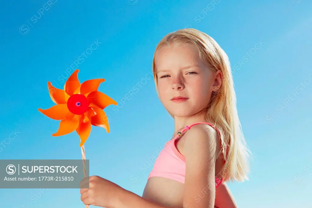 Girl holding toy windmill