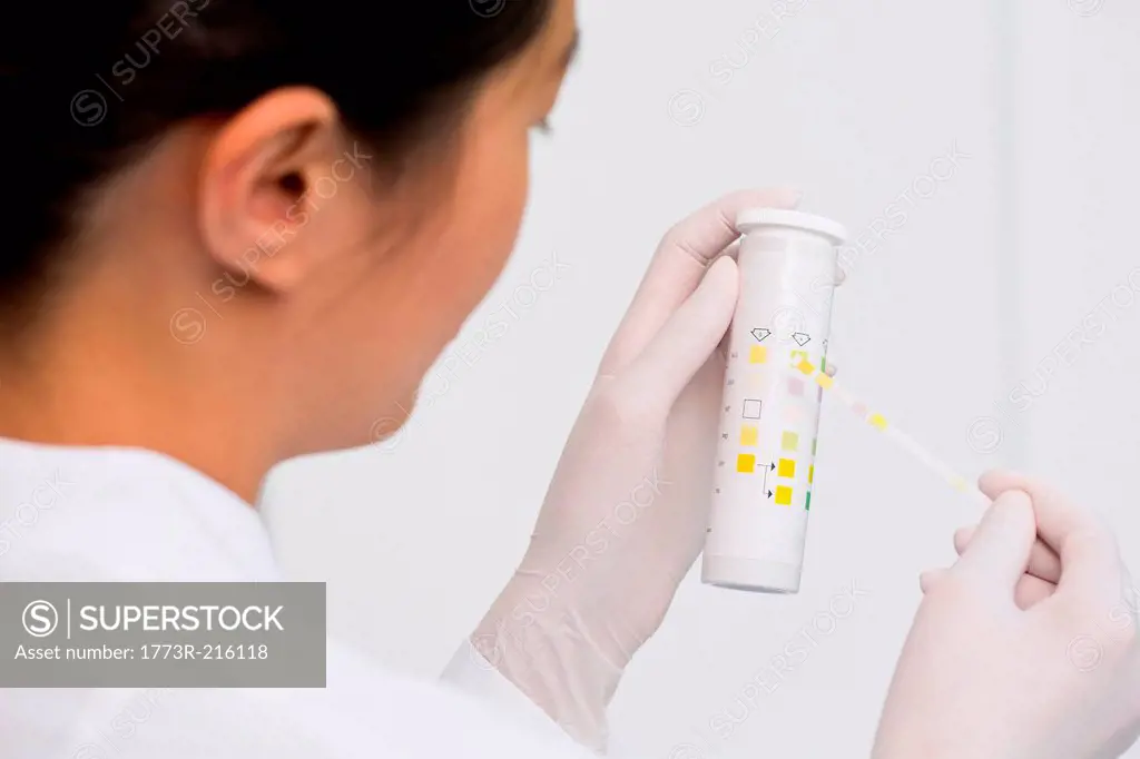 Female scientist testing urine sample