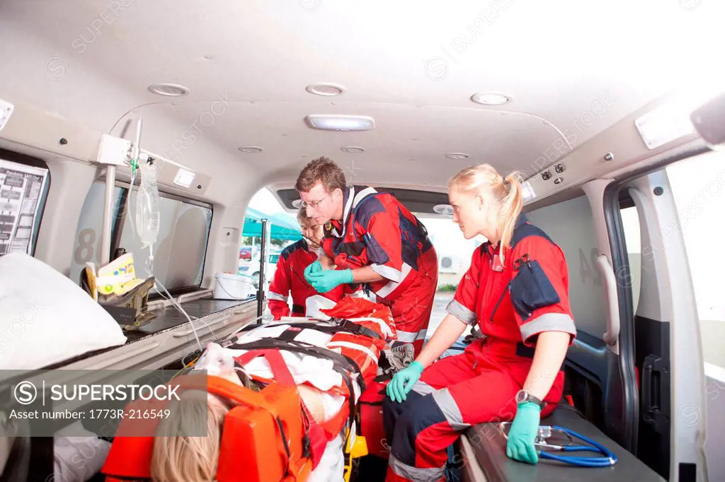 Paramedics in ambulance working with patient
