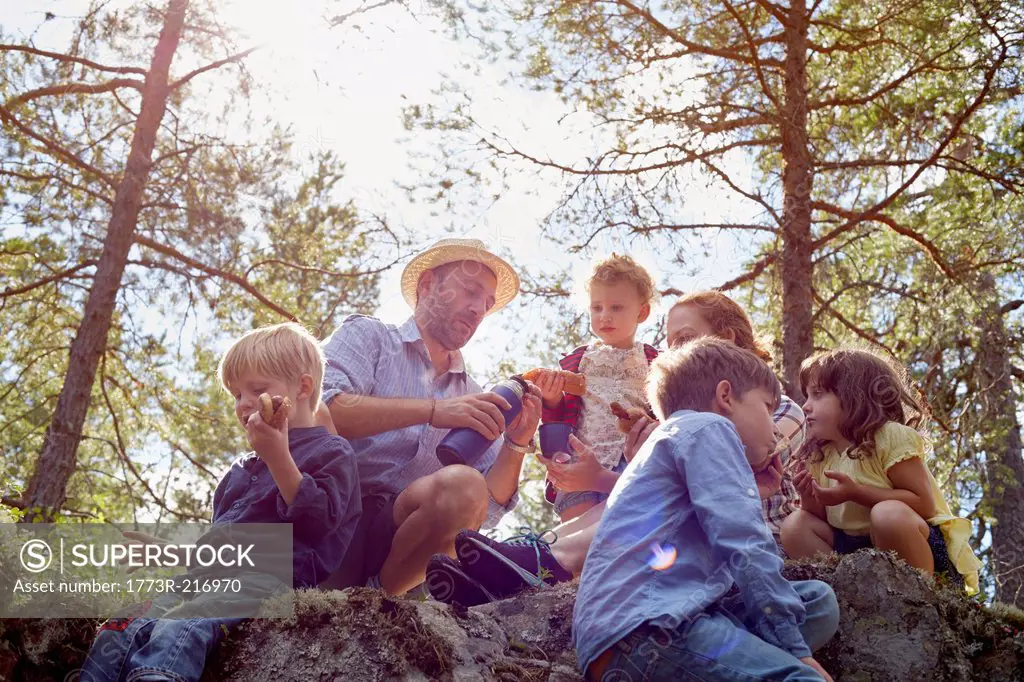 Family having picnic sitting on rocks